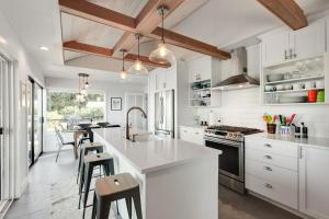 a kitchen with white cabinets and a kitchen island with stools at Saratoga Waterview Escape in Langley