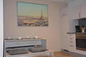a kitchen with a table and a picture of the eiffel tower at Ferienwohnung Christina in Ursensollen