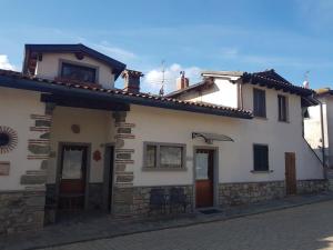 a white house with two doors on a street at Agriturismo Lucatello in Pratovecchio