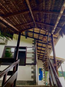 a house with a staircase leading up to a balcony at Pousada Canto Verde in Abraão