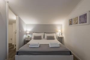 a bedroom with a large bed with two towels on it at B&B L'Ulivo Fiumicino in Fiumicino