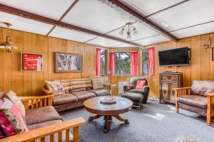 a living room filled with furniture and a flat screen tv at The Wilcox Cabin in Government Camp