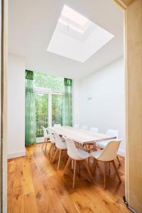 a dining room with a table and chairs at The Woolwich Retreat - Enticing 5BDR House with Parking in Woolwich