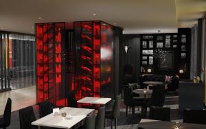 a restaurant with tables and red wine racks at THE SCOTTY Hotel Hamburg in Hamburg