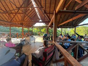 a group of people sitting in chairs in a pavilion at Hacienda Herrera Tambopata in Puerto Maldonado