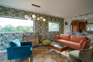 a living room with a couch and a table at La Petite Montagne in Saint-Jorioz