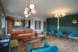 a living room with a couch and a table at La Petite Montagne in Saint-Jorioz