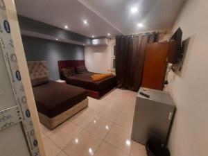 a small room with a bed and a couch at Blue Eyes Hotel in Cairo