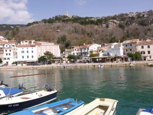 a group of boats docked in a body of water at Apartment Haramina in Baška