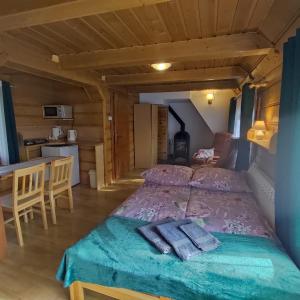 a bedroom with a bed with two towels on it at Domek pod Brzozami in Czarna Góra