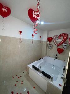 a room with a tub with hearts and balloons at Hotel la Victoria in San Roque