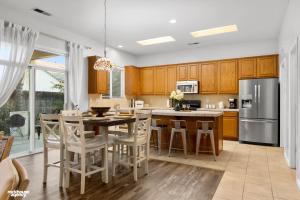 a kitchen with wooden cabinets and a table and chairs at NorthWest Farmhouse in Bakersfield