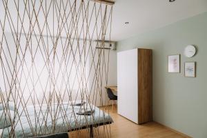 a living room with a wall covered in lines at Constantin Inn in Niš