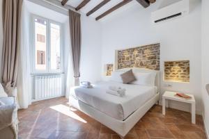 a white bedroom with a bed in a room at Mommy's - Pantheon house in Rome