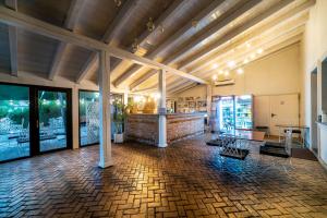 a large room with a brick wall and wooden ceilings at Hanul lui Mihai in Răstoaca