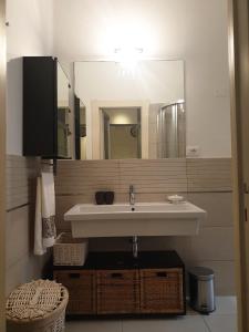 a bathroom with a sink and a mirror at Cleo Tulipano in Falconara Marittima