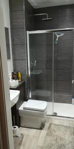 a bathroom with a shower and a toilet and a sink at Jaymar in Fife