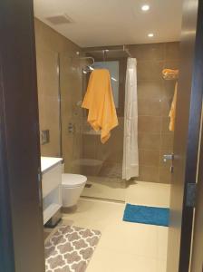 a bathroom with a shower and a toilet and a sink at Acacia Flower AC 8-201 in Salalah