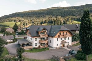 an aerial view of a house with a mountain at Landhaus Holzer in Sankt Margarethen im Lungau