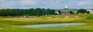 a golf course with a pond in front of a building at Hollywood Casino Tunica in Robinsonville