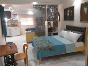 a bedroom with a bed and a living room at CiRa in Dakar