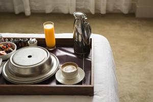 a tray with a cup of coffee and a tea pot at Hollywood Casino Tunica in Robinsonville