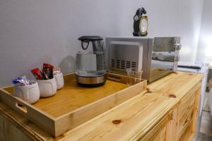 a counter with a coffee maker on top at The Honeycomb 2 in Kimberley