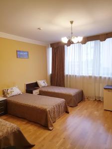 a hotel room with two beds and a window at Hotel Obolon-Arena in Kyiv