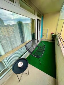 a balcony with a table and a chair and a window at Apartment Skyline by Aux Property in Augsburg