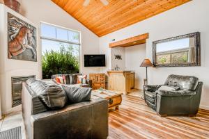 a living room with leather furniture and a tv at Rim Village A1 in Moab