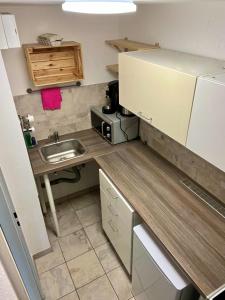 a small kitchen with a sink and a microwave at Apartment Skyline by Aux Property in Augsburg