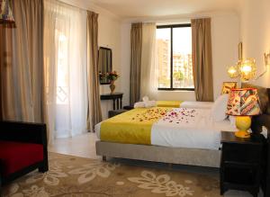 a hotel room with a large bed and a window at Majorel Pearl Hotel-Riad-Restaurant Piscine&Spa in Marrakech