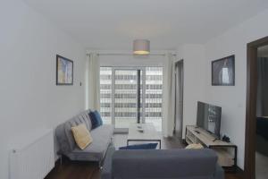 a living room with a couch and a large window at Stylish, 2-bedroom flat, Central Southend Flat, 11th floor in Southend-on-Sea