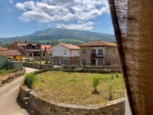 a view of a village with a mountain in the background at Casa junto a Reserva del Saja, bosque y montaña in Arenas de Iguña