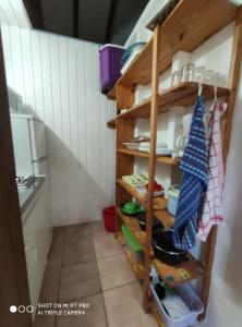 a kitchen with wooden shelving in a room at Bakoulélé en Guadeloupe in Bouillante