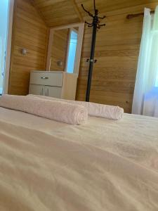 a bedroom with a bed with a towel on it at Bujtina Arturi in Valbonë