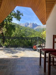 a patio with a fence and mountains in the background at Bujtina Arturi in Valbonë