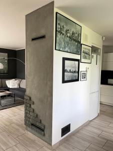 a living room with a wall with pictures on it at Cicha Ostoja in Miłków