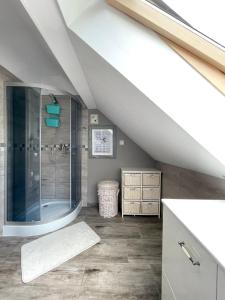 a attic bathroom with a shower and a sink at Cicha Ostoja in Miłków +35 photos