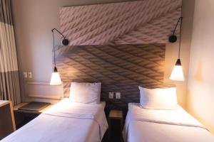 Letto o letti in una camera di Ibis Lorena - Circuito da Fé