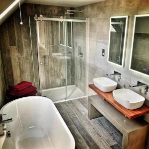 a bathroom with two sinks and a tub and a shower at Laburnam Villa - Luxury 4 bedroom accommodation in the heart of Killin in Killin
