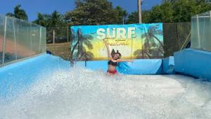 a woman on a water slide at a water park at On Vacation Girardot Resort in Girardot