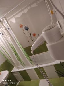 a white hairdryer hanging on a wall at CASA RUSTIK in Bîltişoara