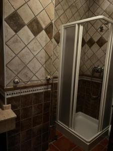 a shower with a glass door in a bathroom at Albergue Rural Gorillo in Gor