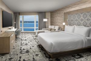 a hotel room with a bed and a large window at Silver Cloud Hotel Tacoma at Point Ruston Waterfront in Tacoma