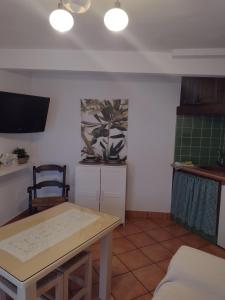 a living room with a table and a chair at La Casita de Zahara de la Sierra in Zahara de la Sierra +12 photos