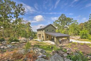 a house in the middle of a field at The Glabin Garrison Gem with Deck and Fire Pit! in Garrison