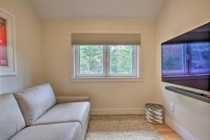 a living room with a couch and two windows at The Glabin Garrison Gem with Deck and Fire Pit! in Garrison