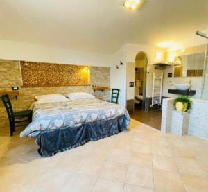 a bedroom with a large bed and a kitchen at Costa del Gallo in Pacentro