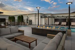 a patio with a fire pit and a pool at Silver Cloud Hotel Tacoma at Point Ruston Waterfront in Tacoma